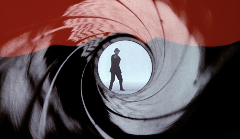 Decorative image showing a frame from the Gunbarrel sequence of Dr No, where a man turns and shoots the camera.