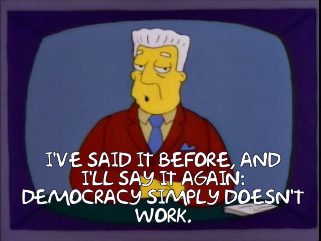 Screencap of the Simpsons with Kurt Brockman (newsreader) saying"I've said it before and I'll say it again; democracy doesn't work."